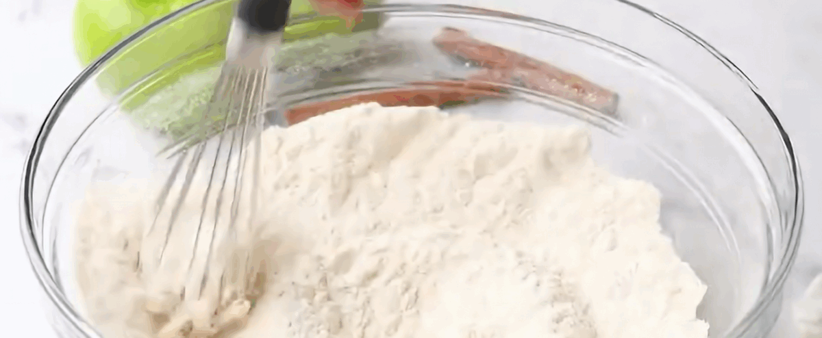 Combining the dry ingredients to make the muffins.