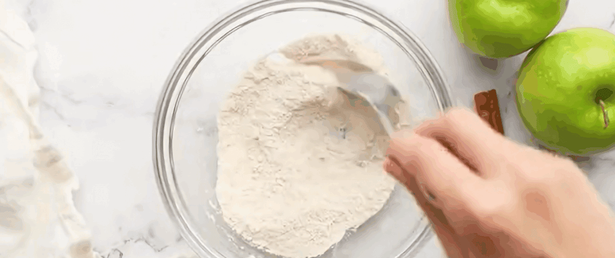 Combing the ingredients to make the streusel in a glass bowl.