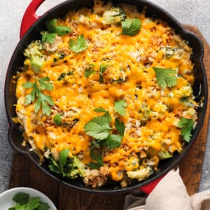 overhead skillet of chicken and broccoli rice with melted cheese