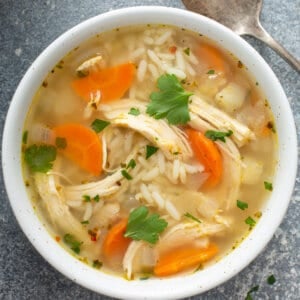 overhead bowl of chicken soup with rice and carrots