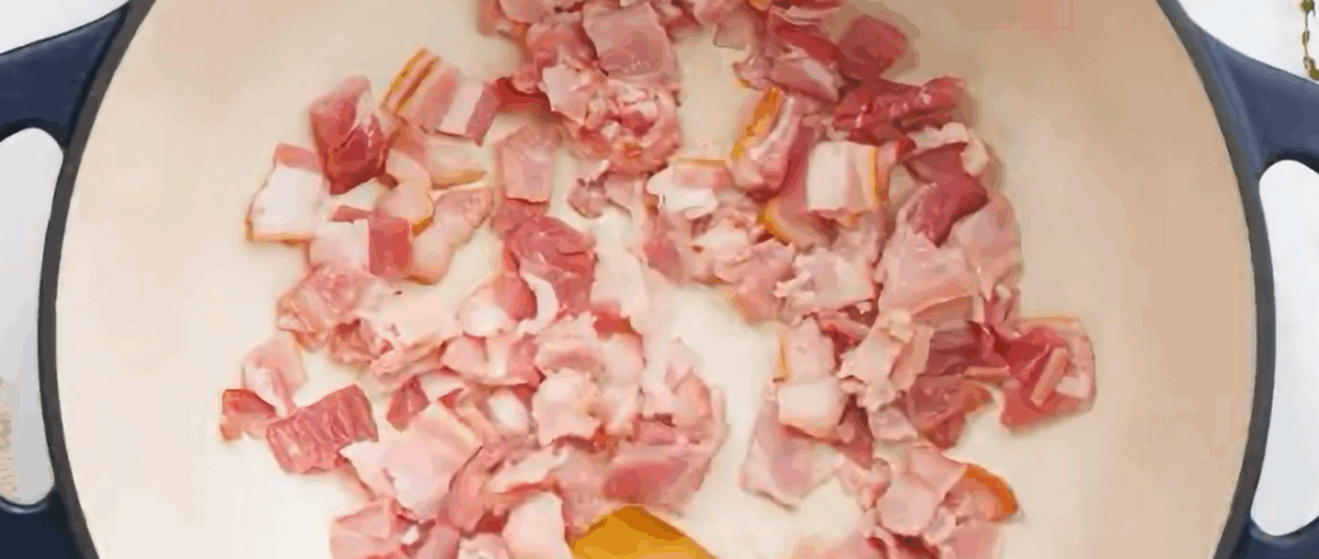 Cooking bacon in a large pot. 