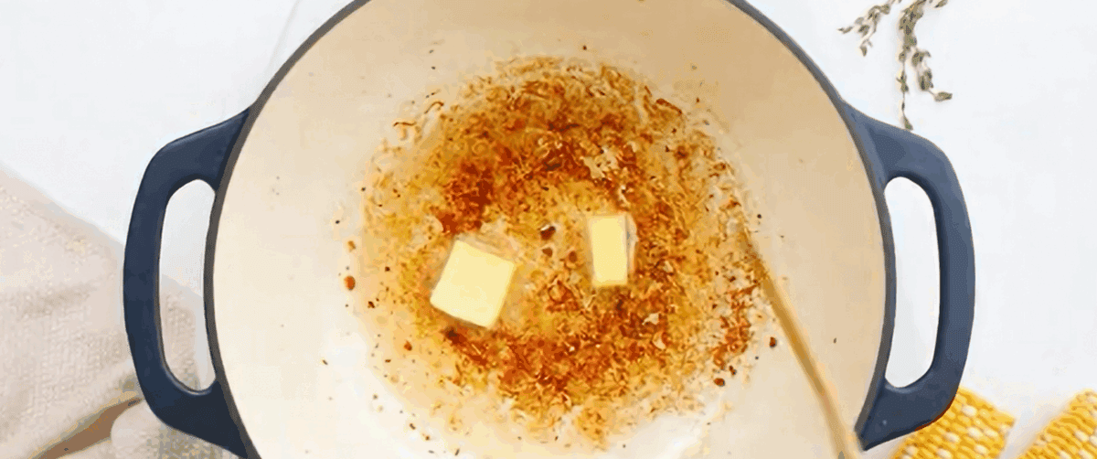 Meoting butter in the pot with bacon grease. 