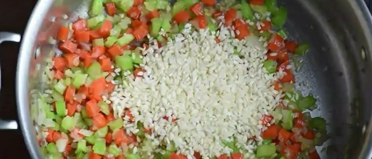 Adding rice to the saucepan.