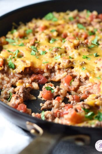 cheesy Mexican rice stirred in skillet