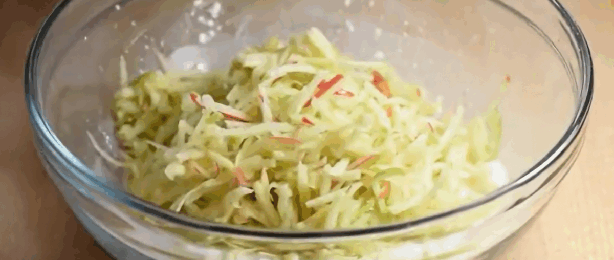 Grated apples in a bowl with sugar and cornstarch.