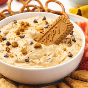 A bowl of cookie butter dip with a Biscoff cookie in it
