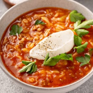 bowl of cabbage roll soup with dollop of sour cream