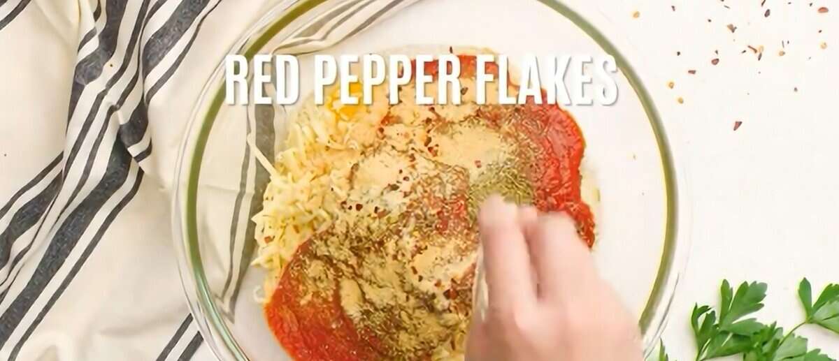 Combining cheese, marinara sauce, and seasonings.