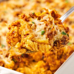 A spoon serving chicken parmesan casserole