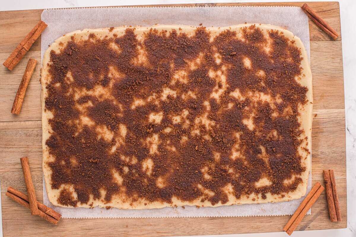 Cinnamon and brown sugar mixture spread out over the dough.