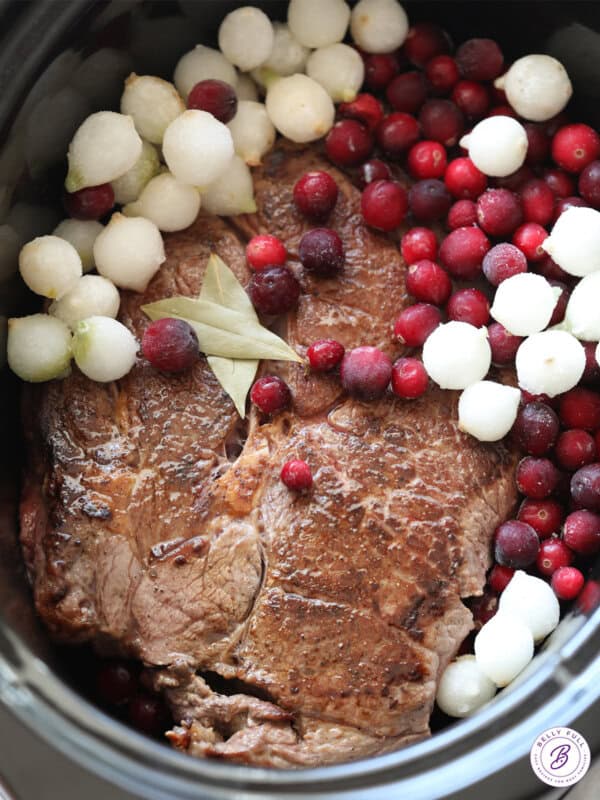 chuck roast, cranberries, and pearl onion inside crockpot