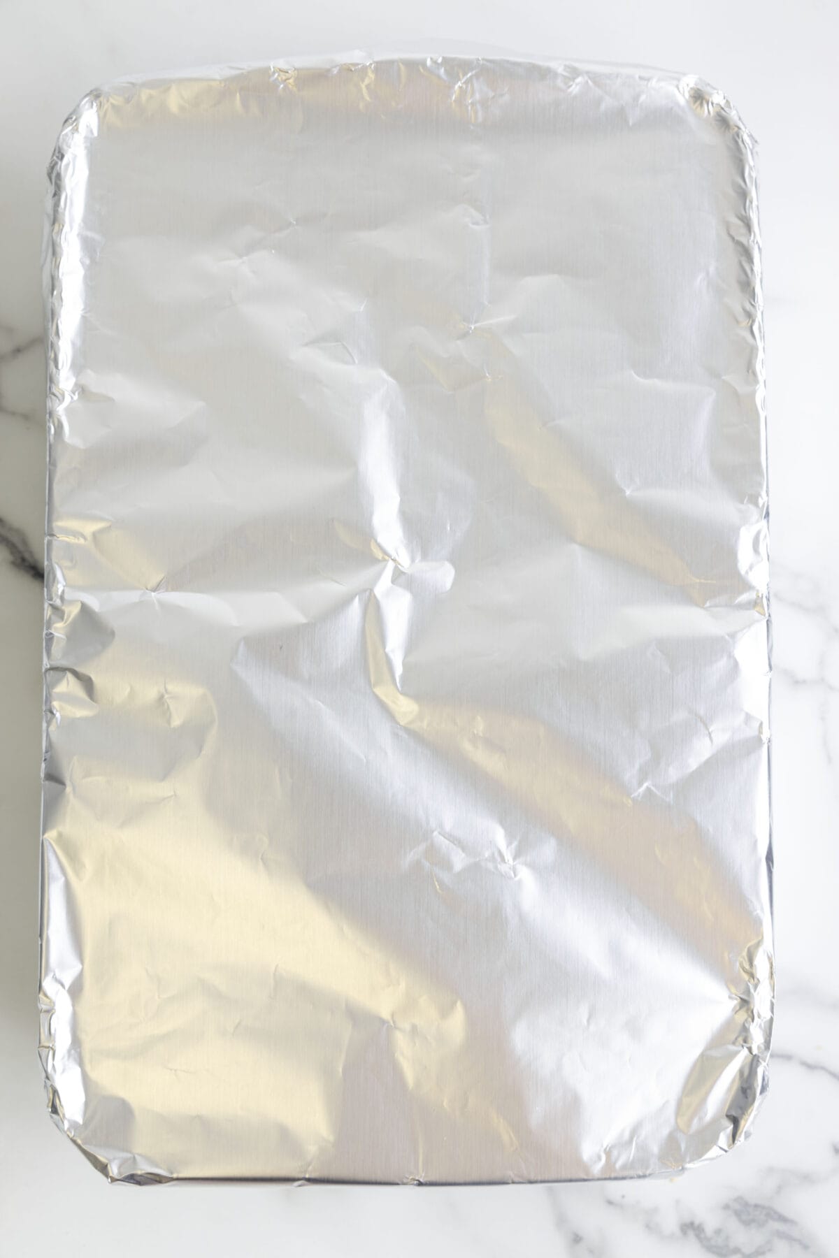 Casserole dish covered with aluminum foil.