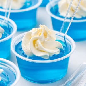 Jack Frost Jello Shots with whipped cream and tasting spoon