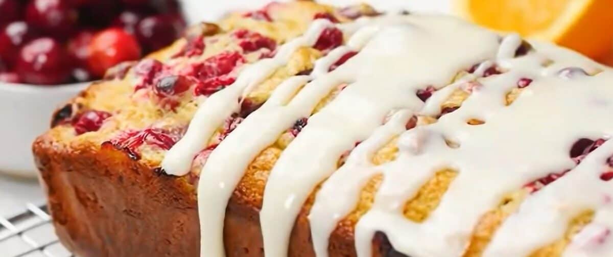 Drizzling the glaze over the loaf.