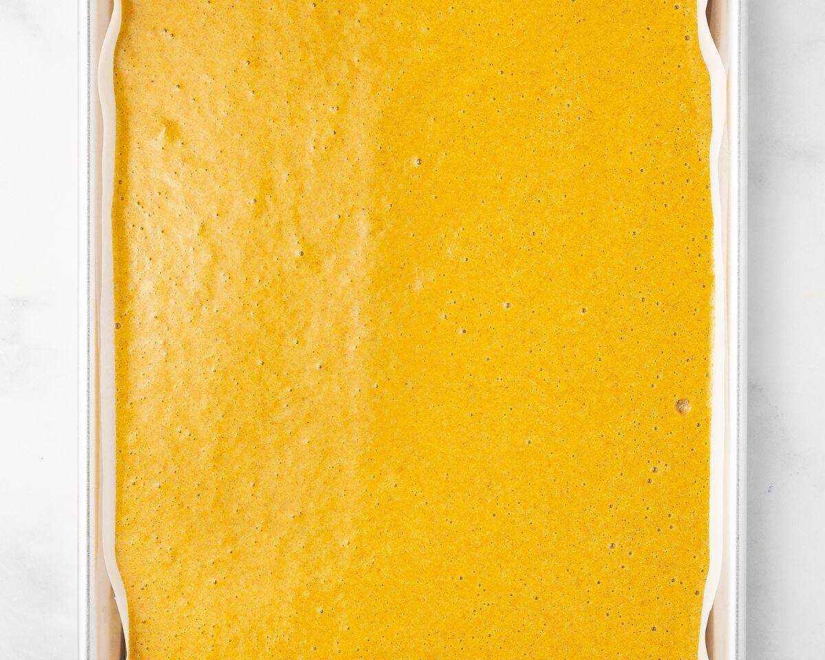 Pumpkin roll batter on the jelly roll pan.