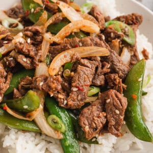 Korean beef bulgogi with peppers and peas served over rice