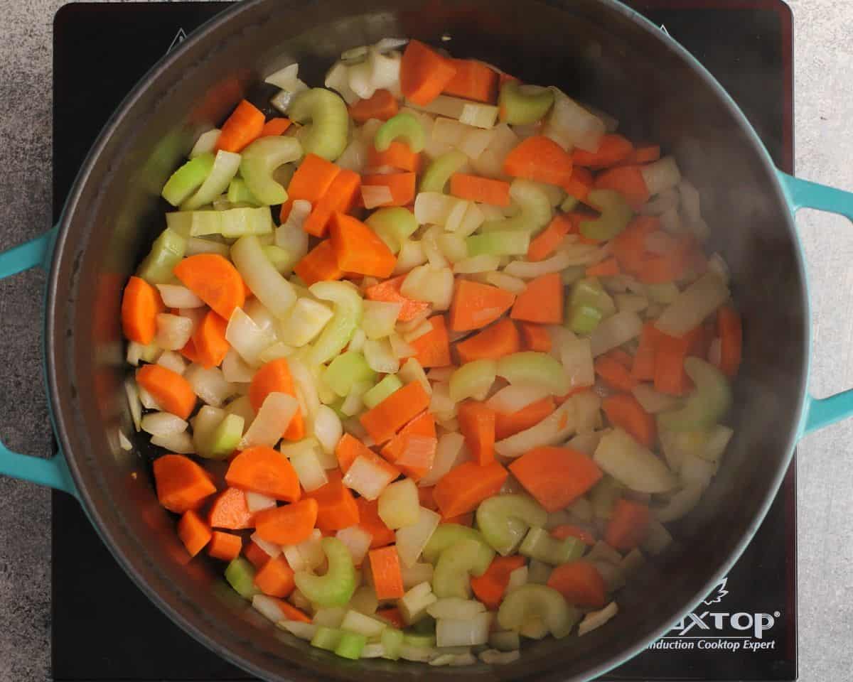 Cooking the veggies in a pot.