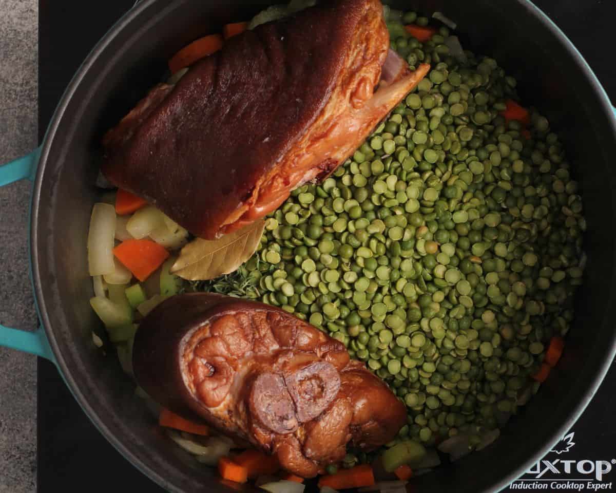 Ingredients to make split pea soup in a pot.