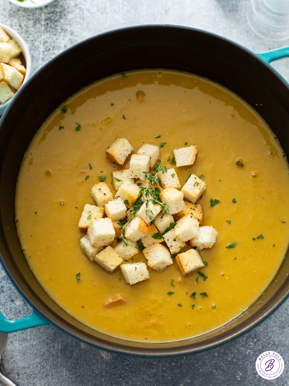 big pot of pea and ham soup with croutons