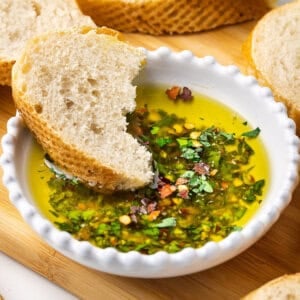 bowl of bread dipping oil with crusty bread piece