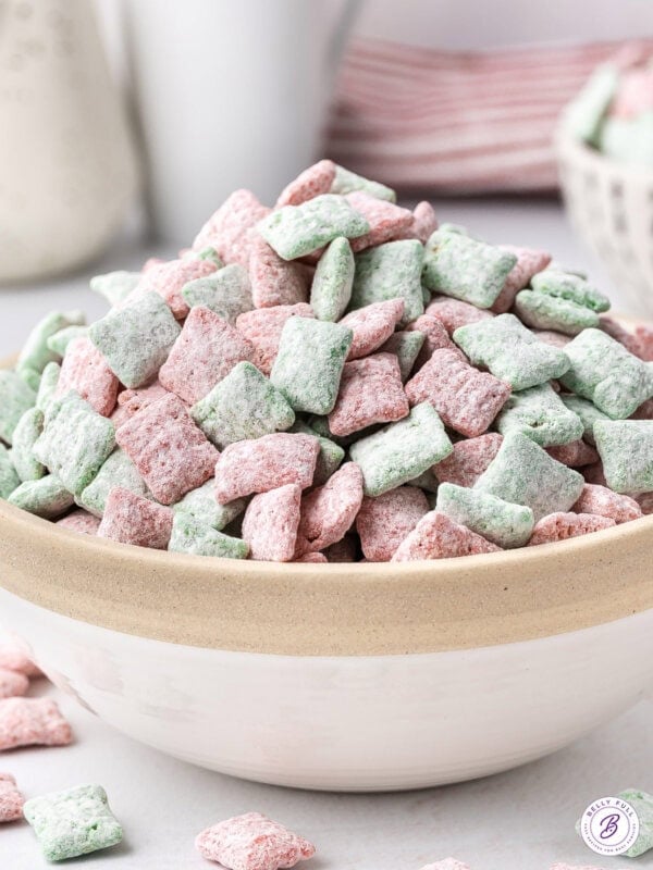 Christmas Muddy Buddies piled high in bowl