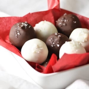 bowl of white and dark chocolate truffles in red tissue paper