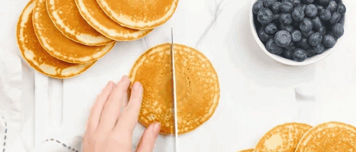 Cutting the pancakes in half. 