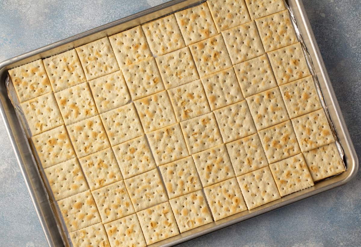 saltine crackers in a single layer covering a baking sheet