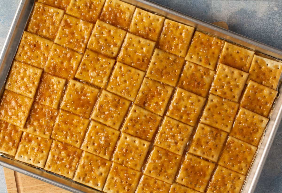 saltine crackers in a single layer on baking sheet covered with toffee