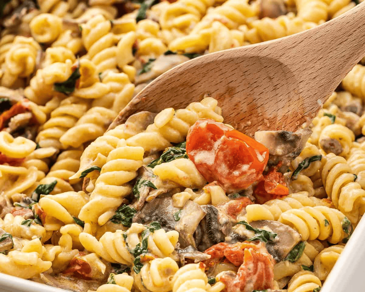 Boursin cheese pasta with a wooden spoon in it. 