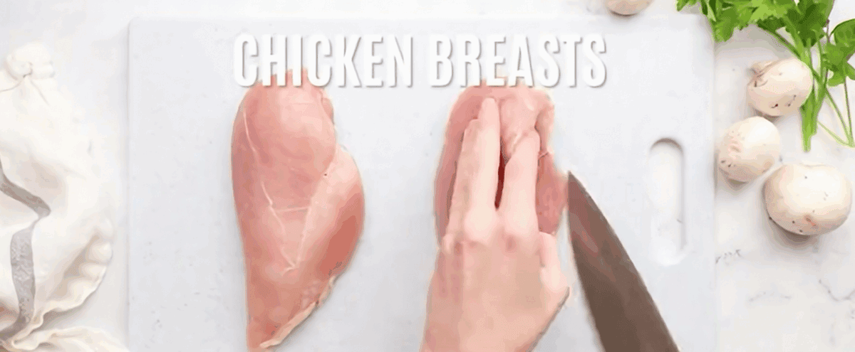 Cutting the chicken breasts.