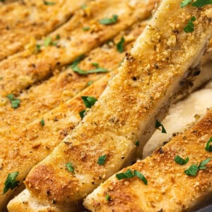 close up baked strips of bread with parmesan