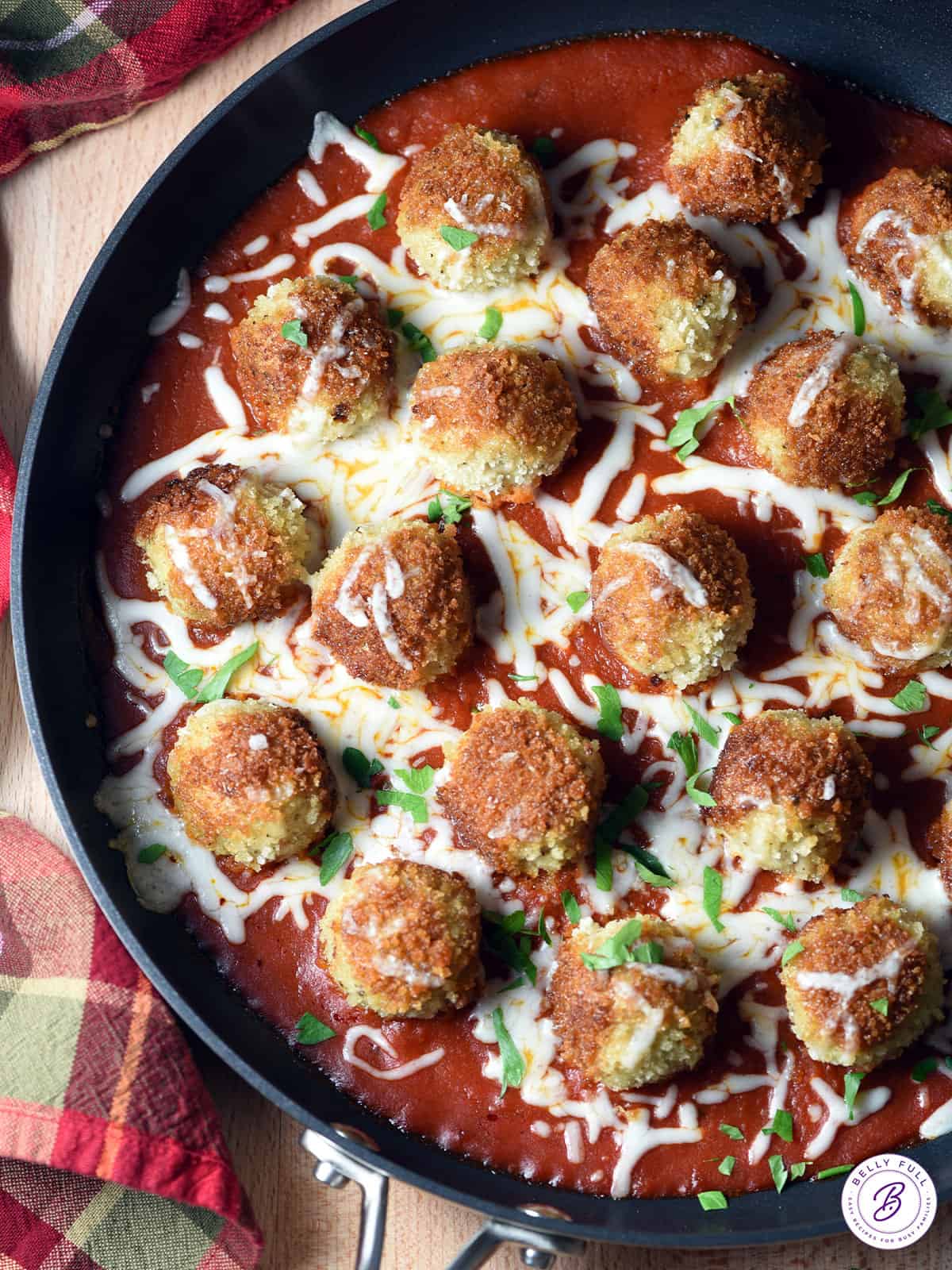 chicken meatballs in skillet with tomato sauce