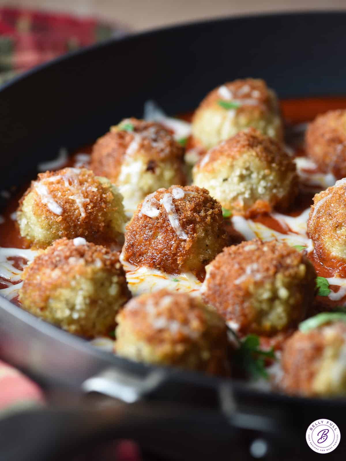 close up breaded chicken meatballs in pan