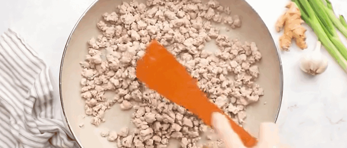 Cooking the pork in a skillet.