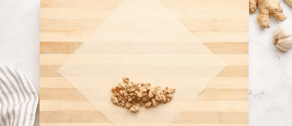 Placing the filling on the lumpia wrapper.