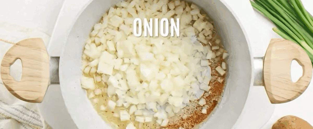 Cooking onions in a white pot.