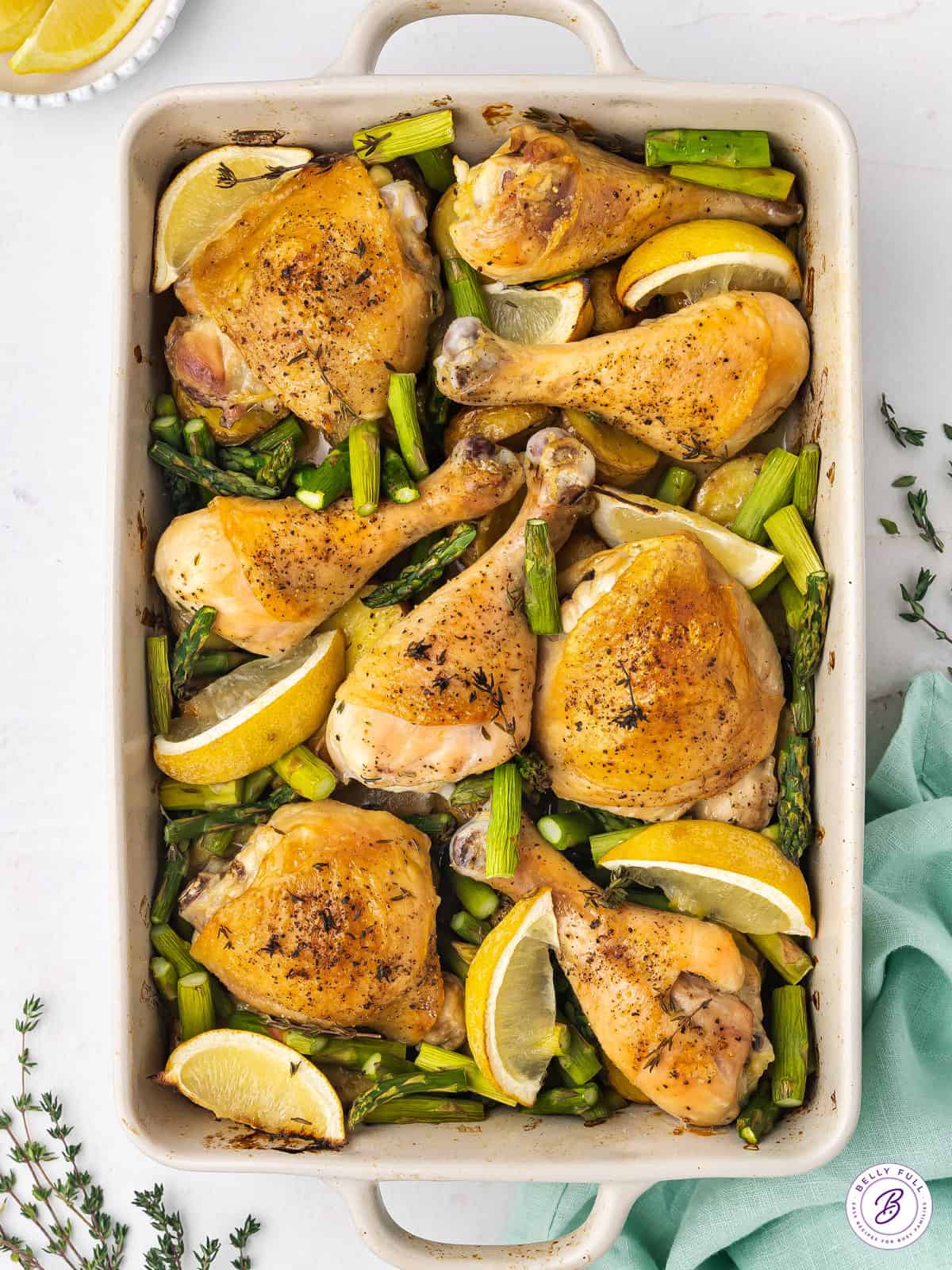 roast chicken dinner with potatoes, asparagus, and lemon