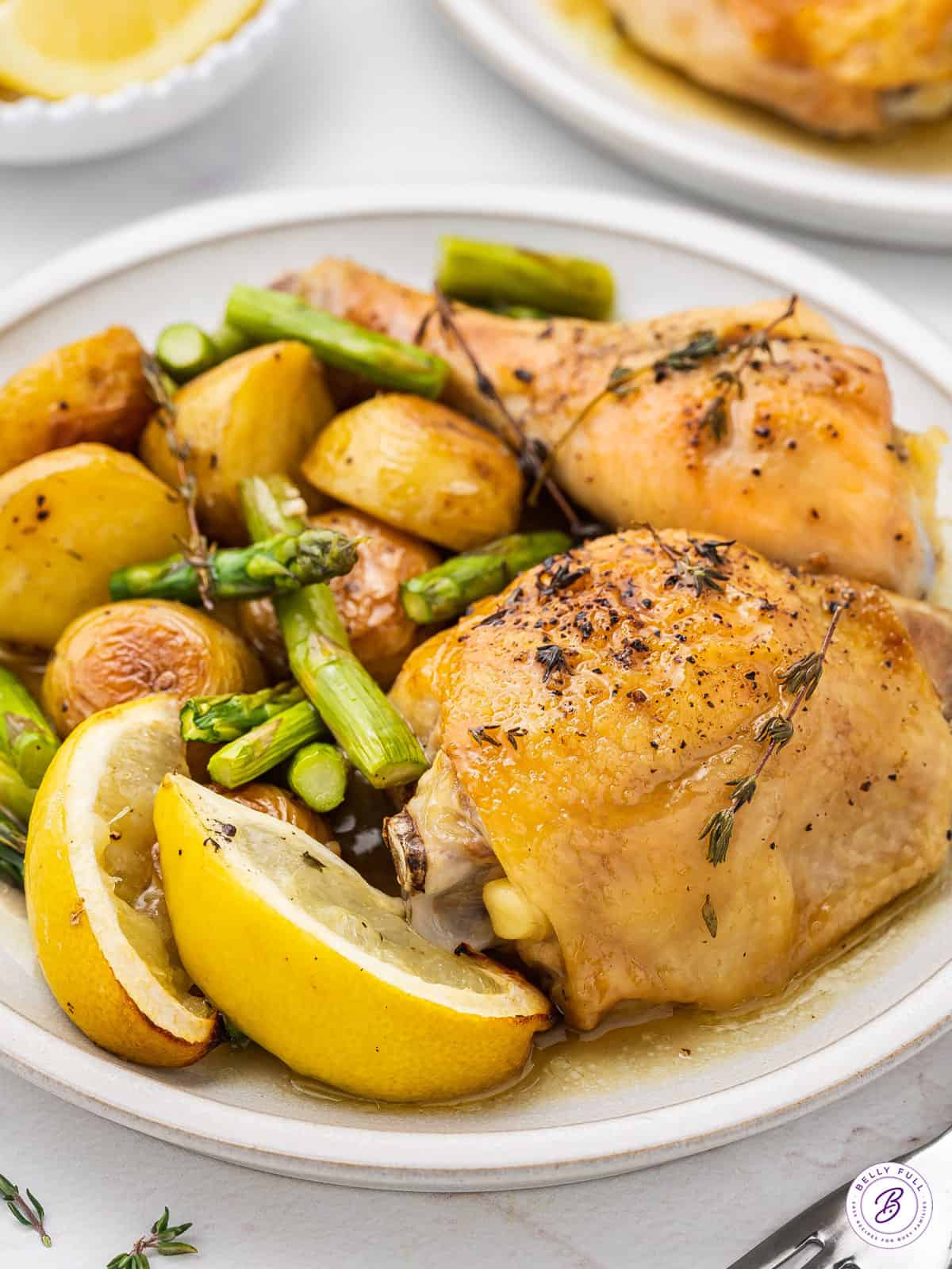 roasted chicken thighs with lemon on plate