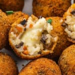 Close up of a fried Italian rice ball, with the inside showing