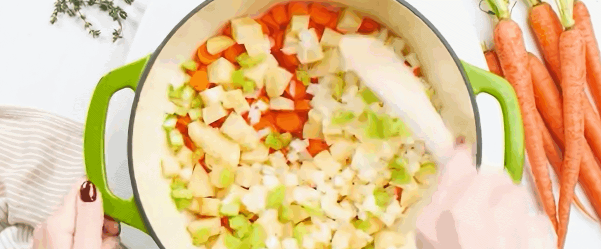 Cooking carrots, celery and onions n a pot. 