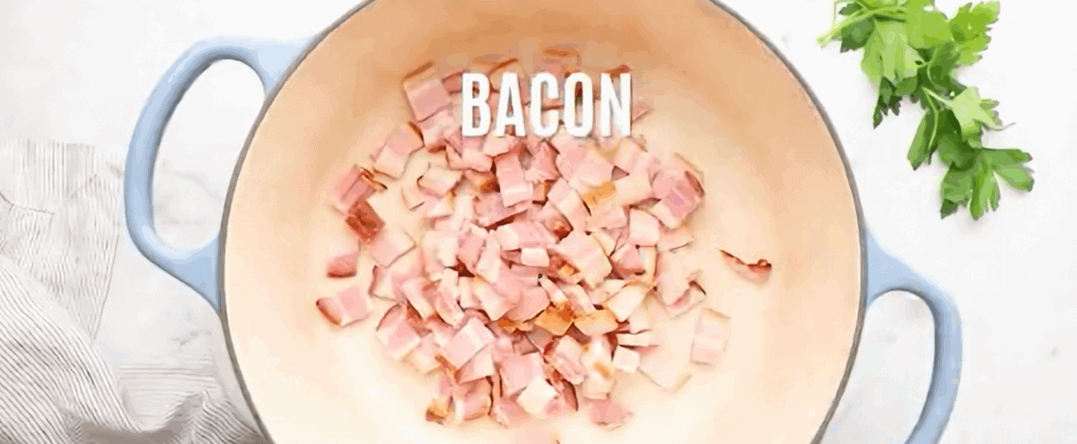 Cooking bacon in a pot with blue handles. 