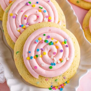 Three Crumbl confetti cookies on a platter