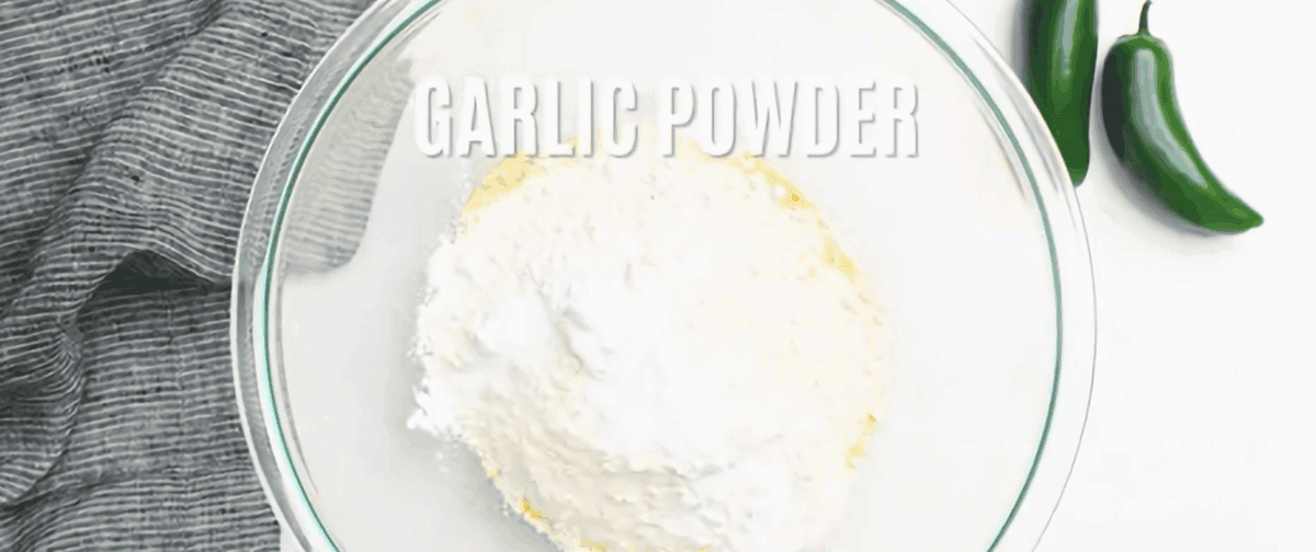 Dry ingredients to make jalapeno cornbread in a glass bowl.