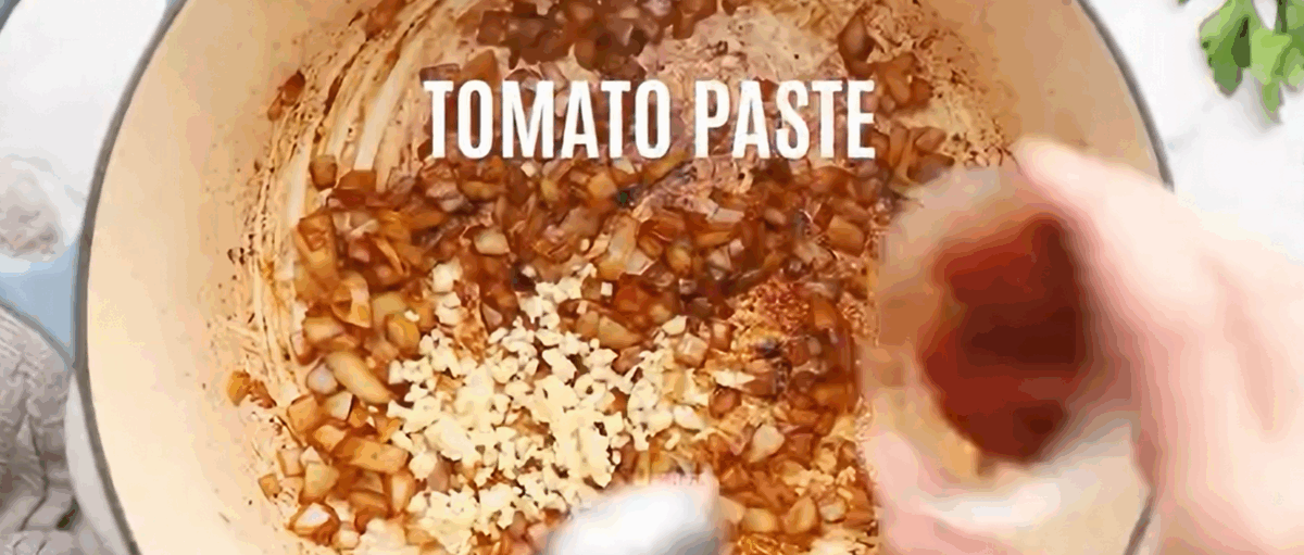 Cooking the onion and garlic with tomato paste.