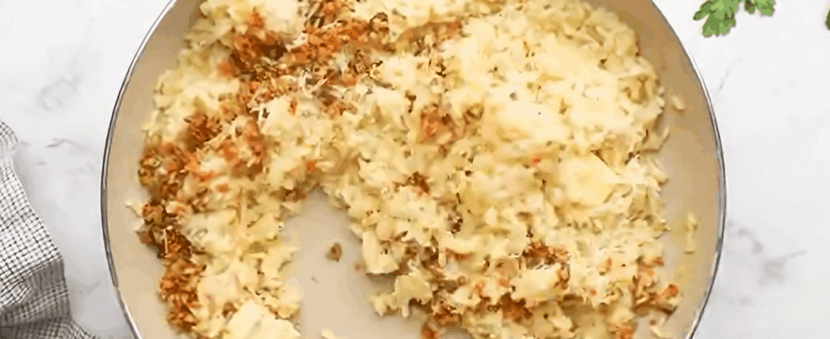 Combining the rice with the veggies and Parmesan cheese.