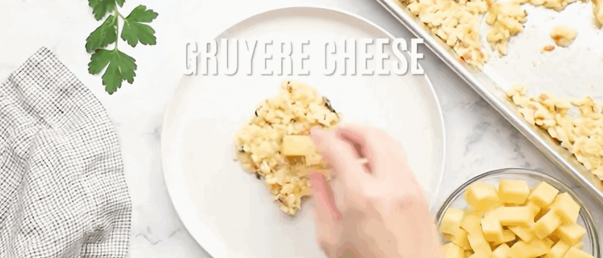 Adding a cube of cheese to the rice ball.