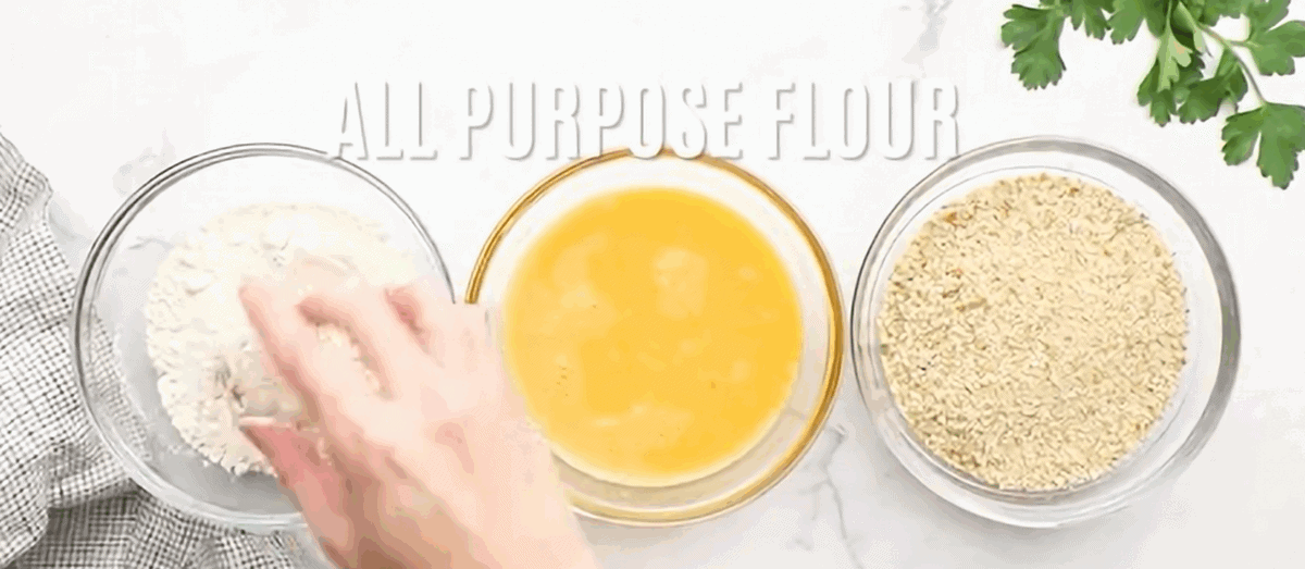 Dredging the rice balls in flour, egg and breadcrumbs.