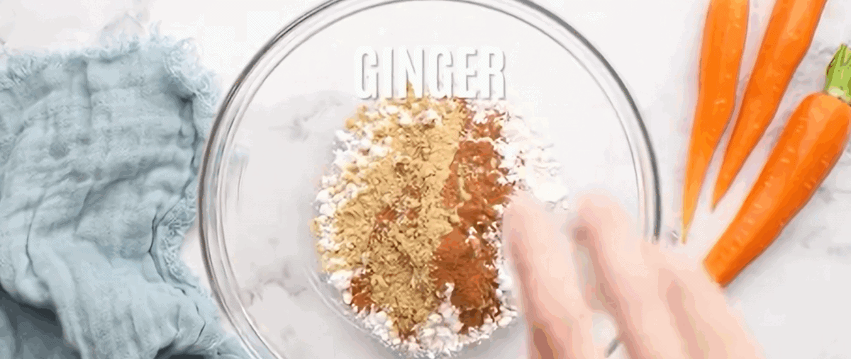 Combining the dry ingredients for the carrot cake roll in a glass bowl. 