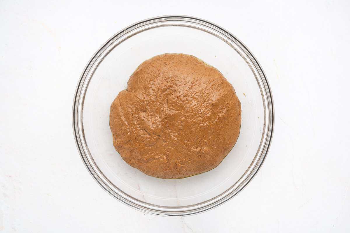 Smooth dough in a glass bowl.